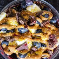 Lotus Bowl · Base: açai, granola. Toppings: banana, blueberries, almond butter, dark chocolate, and drago...