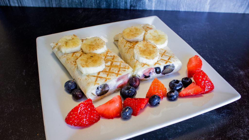 Berries And Cream Panini (V) · Vegan Cream Cheese, Fresh Strawberries and Blueberries, pressed in a flour wrap and topped with Bananas, Cinnamon, and Agave.
