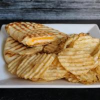 Grilled Cheese Panini · Cheddar, provolone, and havarti cheese melted and pressed on naan bread. With a side of chip...