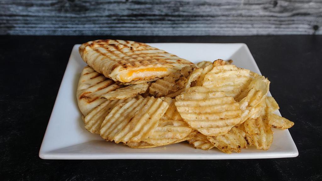 Grilled Cheese Panini · Cheddar, provolone, and havarti cheese melted and pressed on naan bread. With a side of chips or fruit.