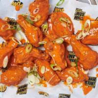 Bangin' Buffalo Wings · Coated in our Buffalo sauce with a bit of a BANG! Then topped with spring onions. Medium spi...