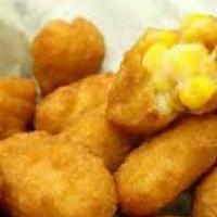 Sweet Corn Bites · Golden fried nuggets of cornbread deliciousness! Drizzled with honey and served with homemad...