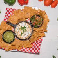 Nacho Trío  · Homemade fried tortilla chips served with guacamole pico de Gallo and cheese dip