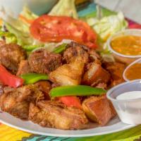 Griot · Fired pork chunks. Served with choice of  white or rice & beans 
and fried plantains