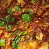 Brisket Nachos · Favorite. Delicious slow cooked brisket with house made chips piled high with shredded chedd...