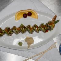 Dragon Roll · Tempura shrimp, asparagus inside. topped with avocado, eel sauce, sesame seeds, masago.