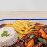 Saltado - Beef · Stir fried tomatoes, red onions, cilantro and soy sauce served with French fries and white r...