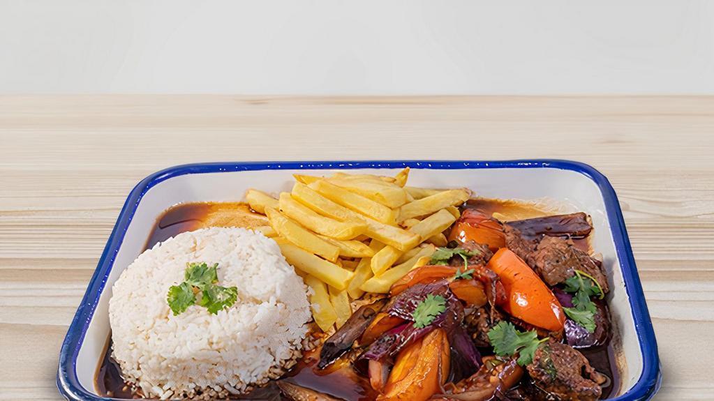 Saltado - Beef · Stir fried tomatoes, red onions, cilantro and soy sauce served with French fries and white rice.