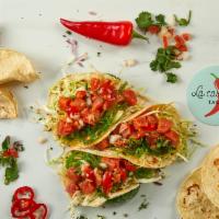 Spicy Tuna Poke Tacos · Three tacos filled with fresh tuna, wakame seaweed salad, white cabbage, chimichurri, and sw...