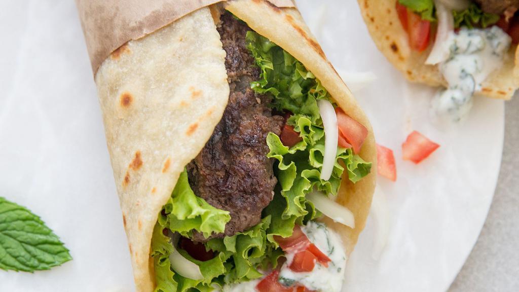 Gyros · Grilled lamb meat with sauteed onions and green peppers  on pita bread, drizzled with tzatziki sauce.