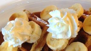 Dulce De Leche & Banana Waffle · Our freshly made Belgian waffle top with dulce de leche (caramel), bananas, powder, and whip...