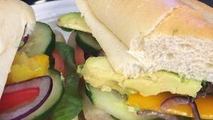 Veggie Sandwich · Romaine lettuce, tomatoes, red onion, black olives, hass avocado, cucumbers, sweet peppers, banana peppers with your choice of pesto or Loca balsamic vinaigrette served on a French baguette.