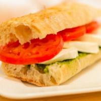 Caprese · Vegetarian. Fresh mozzarella, sliced tomatoes, basil pesto spread, extra virgin olive oil an...