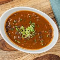 Black Bean Soup · Gluten free. Stewed black beans with peppers, red onions, and herbs.