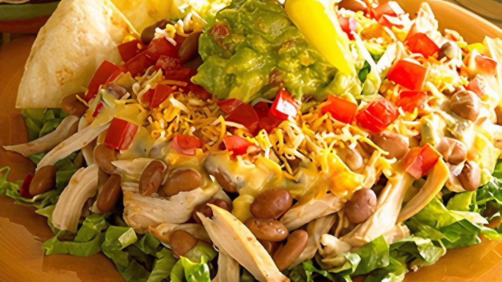 Reynosa Salad · Hand-tossed, fresh lettuce topped generously with your choice of seasoned ground beef or slow-roasted, hand-shredded chicken, chile con queso, our famous charro beans, tomatoes and fresh guacamole, with flour chips.