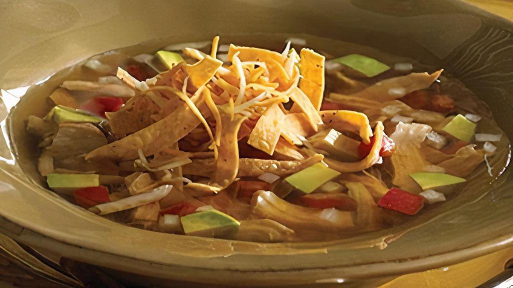 Tortilla Soup · A bowl of our savory blend of seasoned chicken and garden fresh vegetables. Served with a side of sour cream, crispy tortilla strips, diced avocados and blended cheeses.