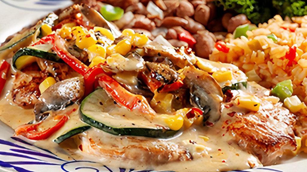 Pechuga Con Calabaza · Lightly sautéed chicken breast topped with a cream sauce blend with zucchini, roasted red peppers, crushed chiles and corn.  Served with charro beans and Mexican rice.