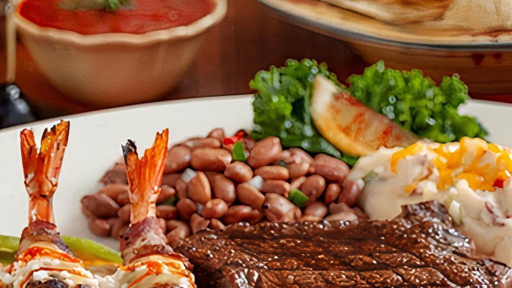 The Ambassador · Fire-grilled 9 oz. Prime Sirloin Steak paired with bacon-wrapped shrimp stuffed with a sliver of jalapeño, sitting atop a roasted Anaheim pepper and topped with chile con queso. Served with Papas con Chile and charro beans.