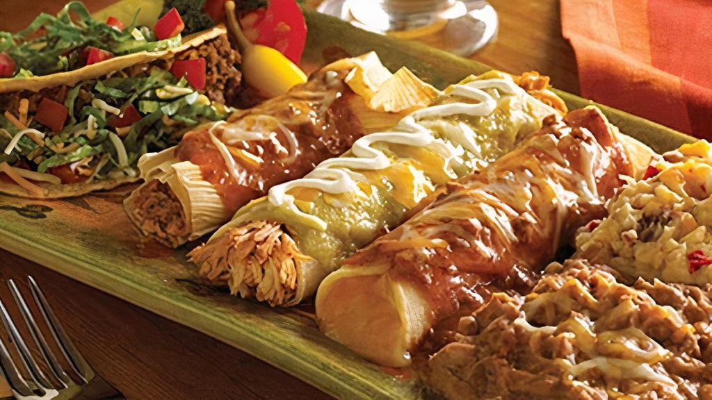 Juarez · Crispy beef taco, tamale, sour cream chicken and cheese hand-rolled enchiladas.  Served with refried beans and your choice of Papas con Chile™ or Mexican rice.