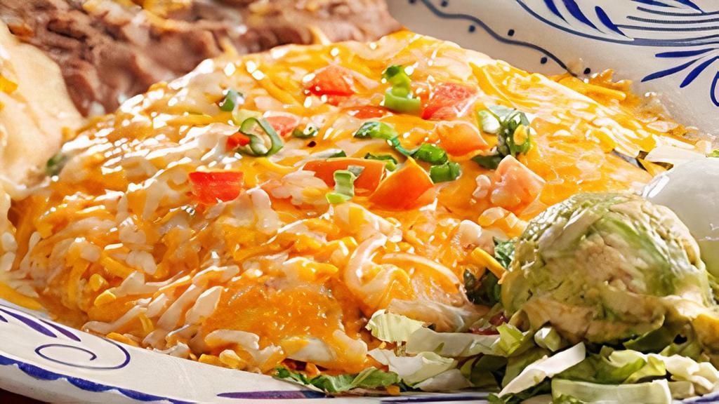 Chicken Quesadilla · Fire-grilled, marinated fajita chicken quesadilla topped with melted cheese served with refried beans and your choice of Papas con Chile™ or Mexican rice.