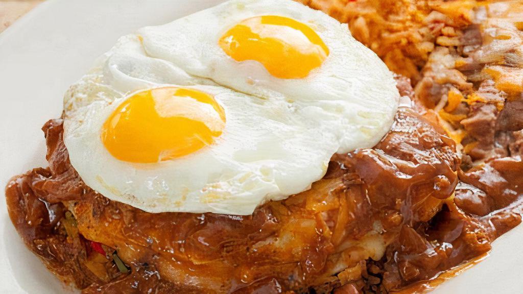 Mi Abuelo'S Manjar · Grandfather’s favorite meal features three stacked enchiladas layered with beef, cheese and chile con carne. Topped with two eggs*, and served with refried beans and your choice of Papas con Chile™ or Mexican rice.