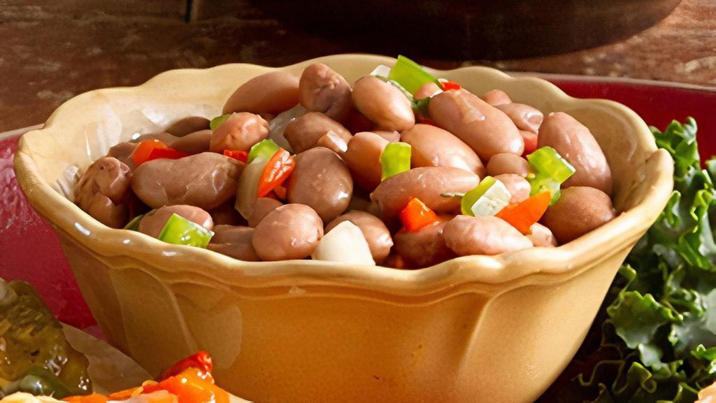 Charro Beans · Pinto beans, expertly seasoned with spices, bacon and pico de gallo.