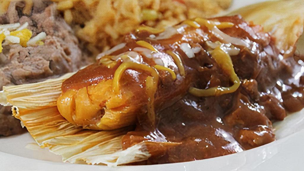 Kid'S Tamale · A beef tamale topped with chile con carne and mixed cheese. Served with French fries, or refried beans and Mexican rice.