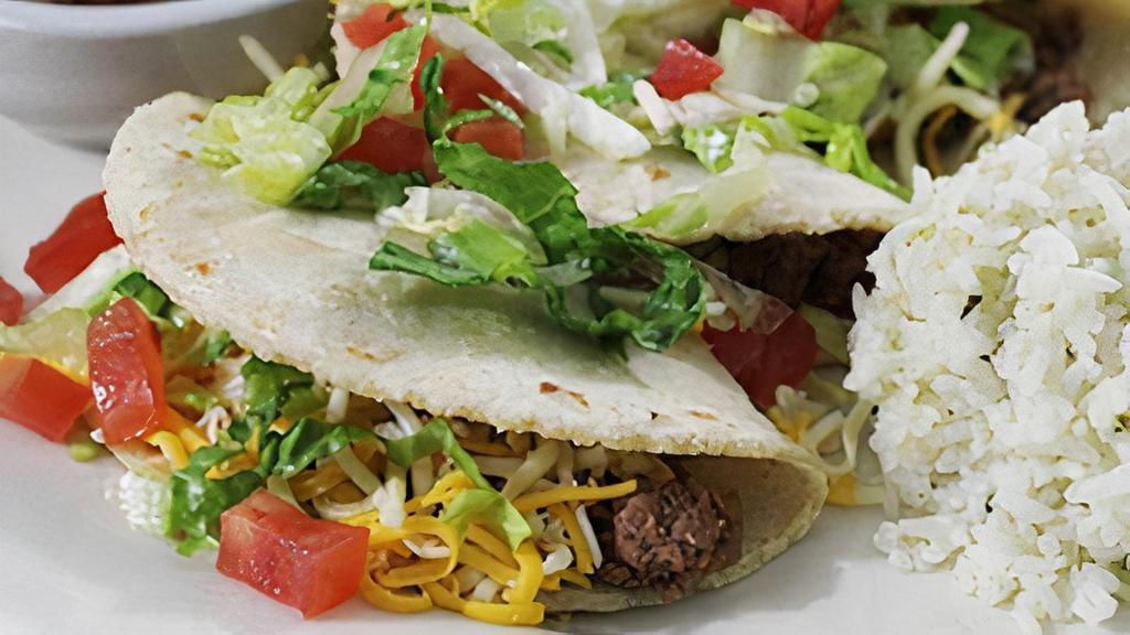 Gluten-Sensitive Soft Taco Plate · Three soft corn tortillas with ground beef, lettuce and mixed cheeses. Served with your choice of two sides: refried beans, charro beans, cilantro lime rice, seasonal vegetables.