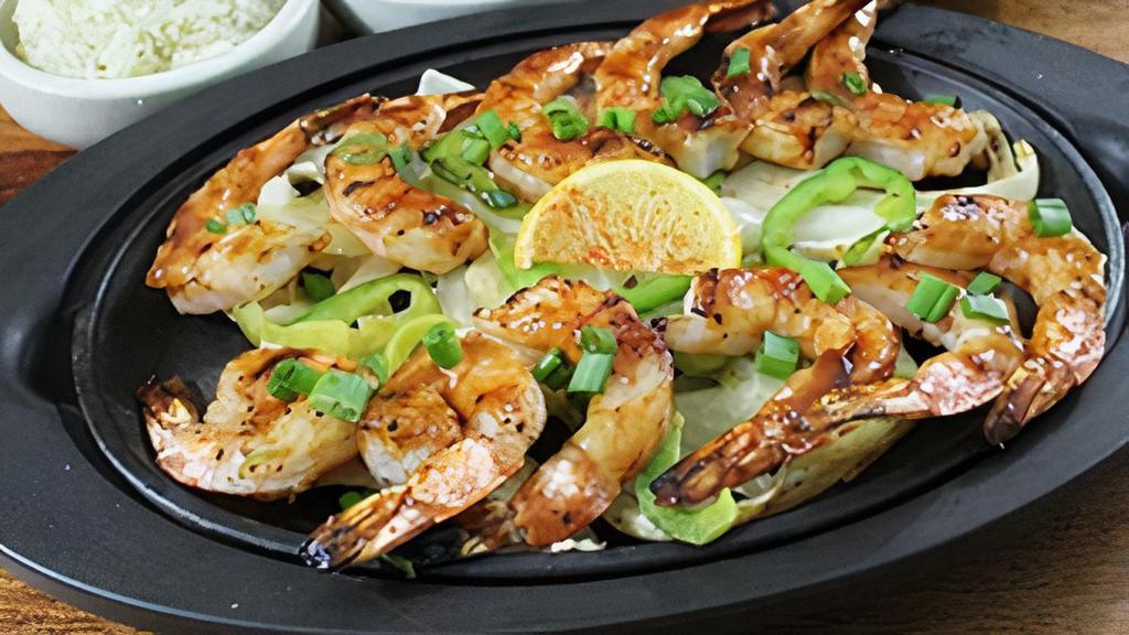 Gluten-Sensitive Shrimp Fajitas · Fire-grilled barbeque shrimp with fresh vegetables, cilantro lime rice, black beans, guacamole, sour cream, shredded cheese, pico de gallo and your choice of soft corn tortillas or fresh Romaine leaves for wrapping.