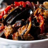 Peppered Snails · Black snails sautéed with onions and hot peppers
