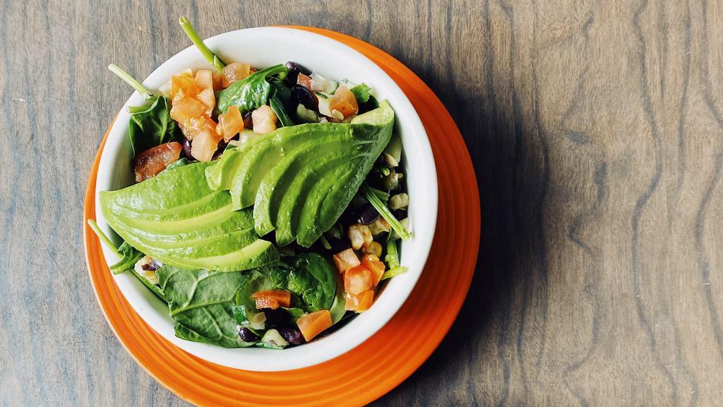 Spinach Salad · Vegetarian. Corn & black bean salad (corn, black beans, cucumber, tomato) on a bed of spinach topped with avocado & served with our house made cilantro lime vinaigrette.  Option to add a protein at an upcharge.