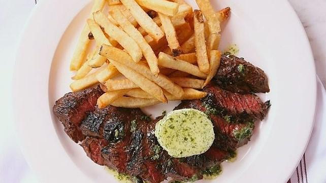 Broiled Hanger Steak & Frites · With mesclun salad, caramelized onions, port wine butter, frites. Gluten-free.