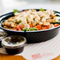 Grilled Chicken Salad · Grilled tender slices of marinated chicken on a bed of fresh lettuce, tomatoes, cucumbers, S...