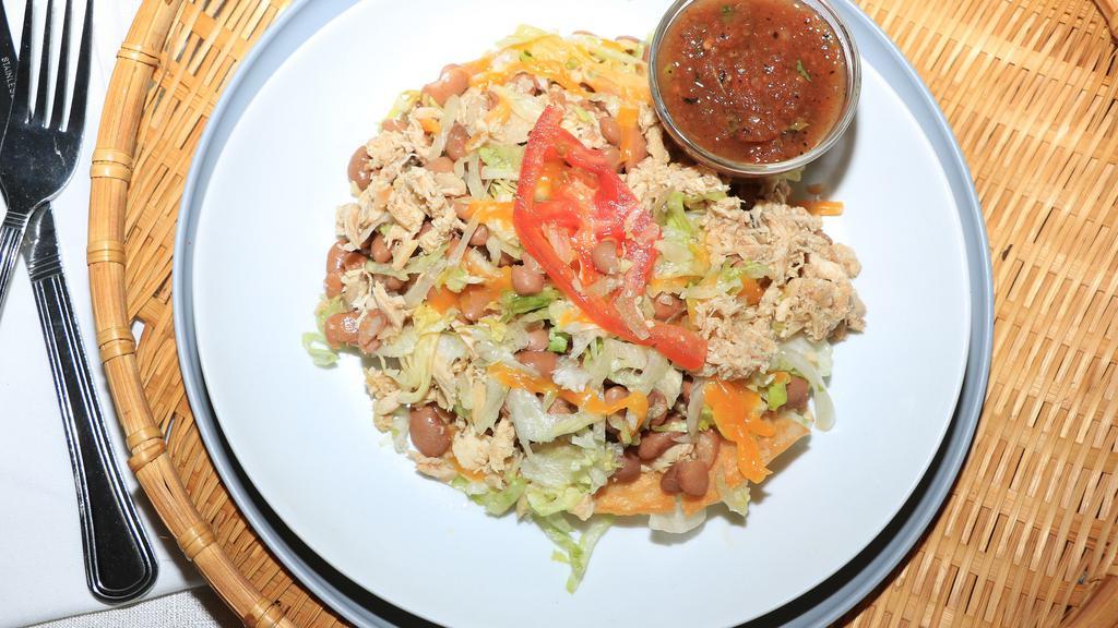 Tostada · Chicken, Beans, Lettuce, cheese & tomatoes.
