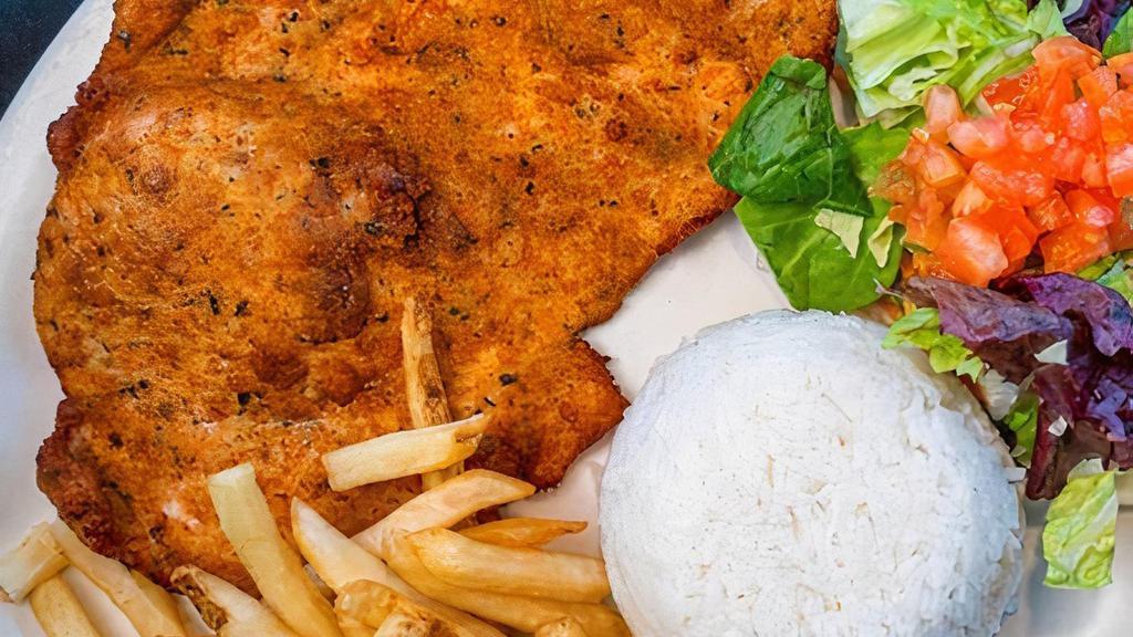 Milanesa De Pollo · Pounded chicken breast, lightly breaded, and deep fried. Served with white rice, French fries, and salad.
