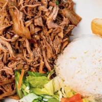 Lechon Asado · Slow roasted pork marinated in a traditional sour orange mojo. Served with white rice, yuca ...