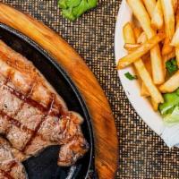Churrasco · A butterfield grillled New York steak. Served with white rice, French fries, salad, and chim...