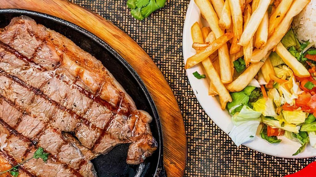 Churrasco · A butterfield grillled New York steak. Served with white rice, French fries, salad, and chimichuri sauce.