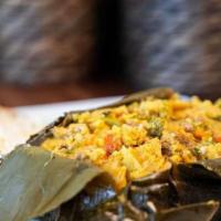 Tamales · A corn cake filled with chicken, pork, potatoes, peas, and carrots all wrapped in a banana l...