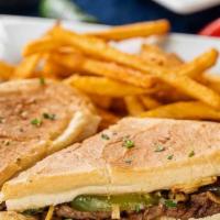 Pan Con Bistec Sandwich · Steak Palomilla sandwich grilled with onions, peppers, tomatoes, and potatoes stick put toge...