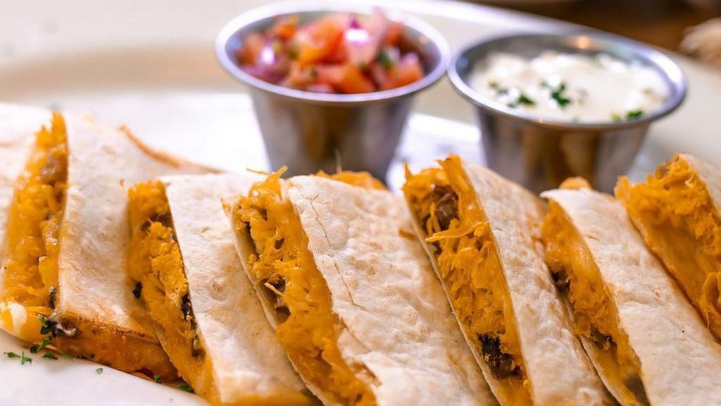 Quesadilla De Carne Y Champinones · Steak and mushroom quesadilla. Grilled steak, sauteed with mushrooms, onions, peppers and mixed cheese in a grilled flour tortilla.