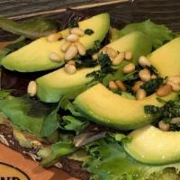 Avocado Toast · Freshly smashed avocado topped with mixed greens, fresh avocado slices & pine nuts with a dr...