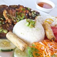 Cơm Đặc Biệt · Special rice platter with grilled chicken, pork chop, Korean short ribs, egg rolls, and sunn...