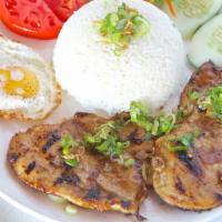 Com Ga · Rice platter with grilled chicken and sunny side up egg.