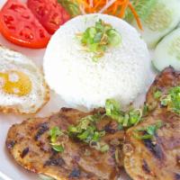 Cơm Sường Heo · Rice platter with pork chop and sunny side up egg.