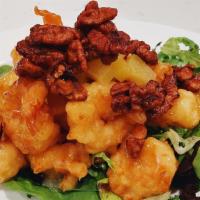 Pineapple Walnut Shrimp · Crispy battered shrimp tossed coconut mayo sauce, over a bed of romaine lettuce, topped with...