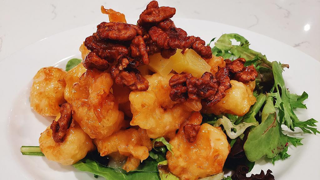 Pineapple Walnut Shrimp · Crispy battered shrimp tossed coconut mayo sauce, over a bed of romaine lettuce, topped with walnuts and pineapples.