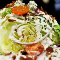 The Missing Piece Salad · Iceberg, baby tomatoes, bleu cheese crumbles, red onions, bacon, bleu cheese dressing.