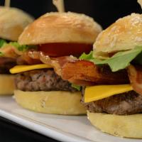 Sliders With Fries · Three angus beef sliders with American cheese, garlic aioli, and caramelized onions.