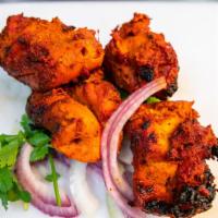Tikka Boti · Boneless chicken thigh marinated in tandoori spices baked in tandoor (clay oven)
